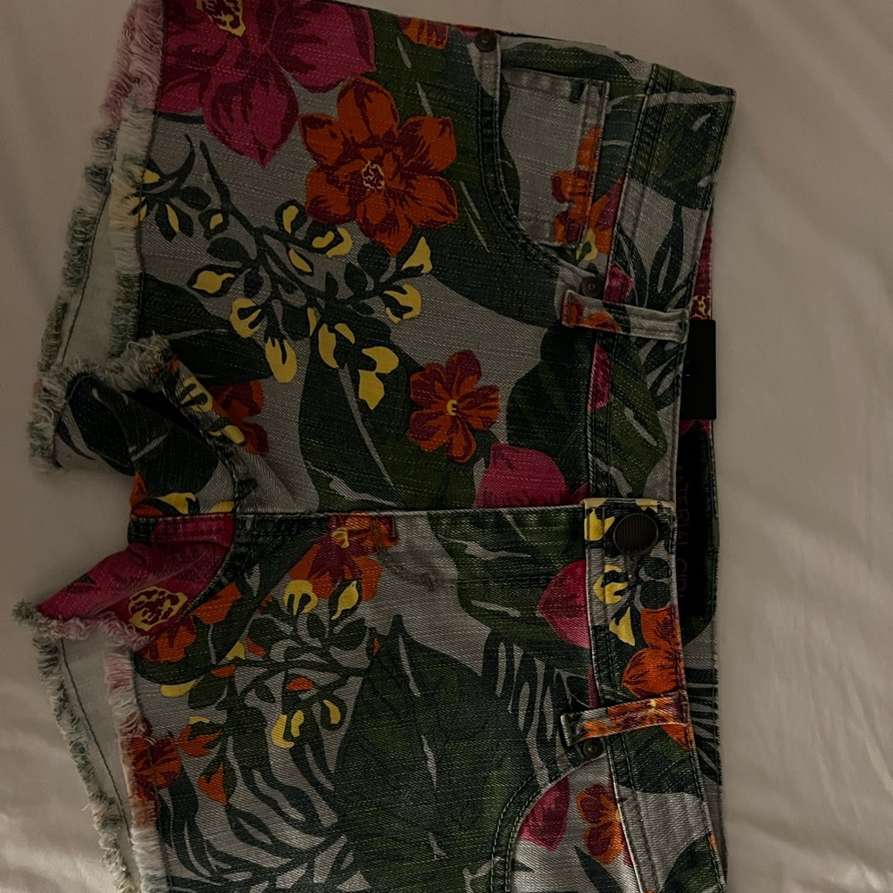 Denim shorts with red and green leaf pattern